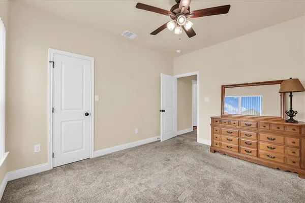 a view of an empty room with cabinet and cabinet