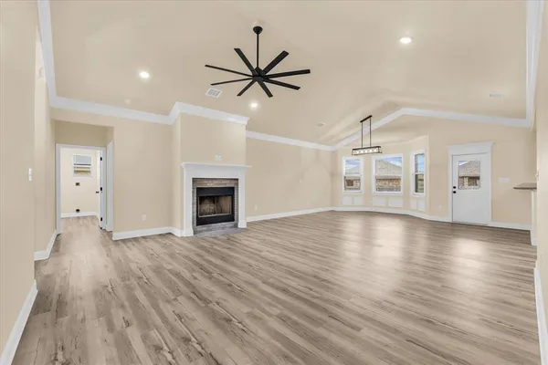a view of a livingroom with wooden floor and a ceiling fan