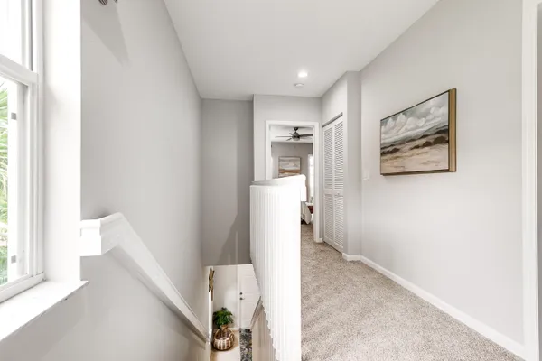a view of hallway with furniture and a window