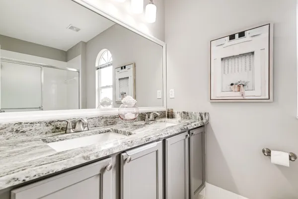 a bathroom with a granite countertop sink a large mirror and a