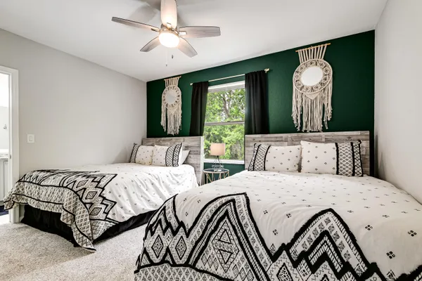 a bedroom with double bed and a large mirror