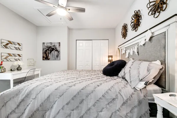 a bedroom with a large bed and a chandelier