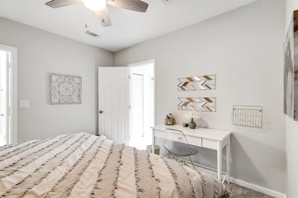 a bedroom with a bed and a dresser in it