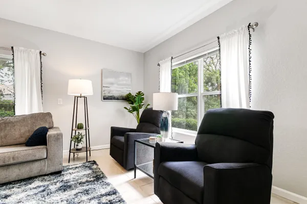 a living room with furniture and a large window