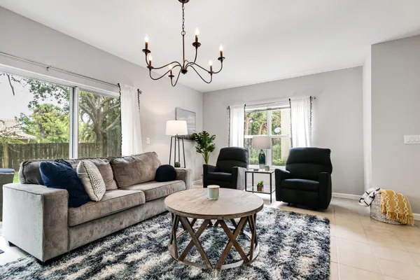 a living room with furniture a window and a chandelier