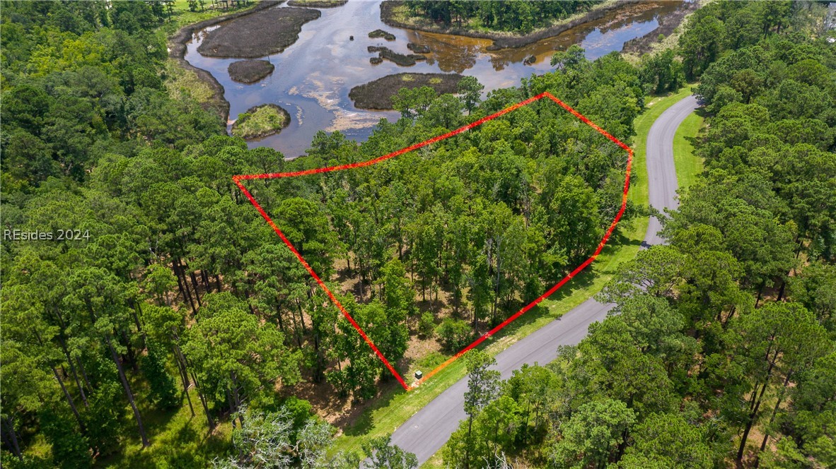 859 Bridle Path Boulevard Hardeeville, SC 29927 - Photo 16 of 40 Aerial view of Lot 27, the magnificent water/marsh views beyond and the frontage along Bridle Path Road. This pond was once part of the historic rice fields of the south. Now it is a place to observe resident shore birds and stunning sunrises to the east.