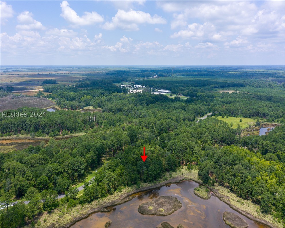 859 Bridle Path Boulevard Hardeeville, SC 29927 - Photo 21 of 40 Aerial view of Lot 27 and the magnificent water/marsh views beyond and Savannah in the distance. This pond was once part of the historic rice fields of the south. Now it is a place to observe resident shore birds and stunning sunrises to the east.