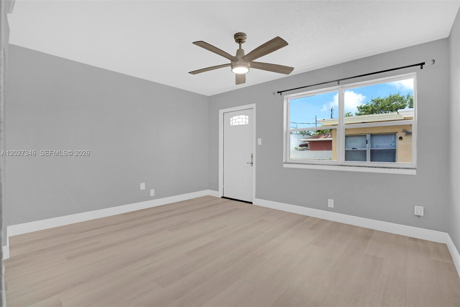 369 Phippen Waiters Road, Unit FRONT Dania Beach, FL 33004 - Photo 3 of 19 a view of an empty room with a window