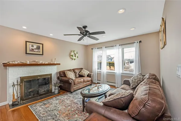 a living room with furniture a fireplace and a large window