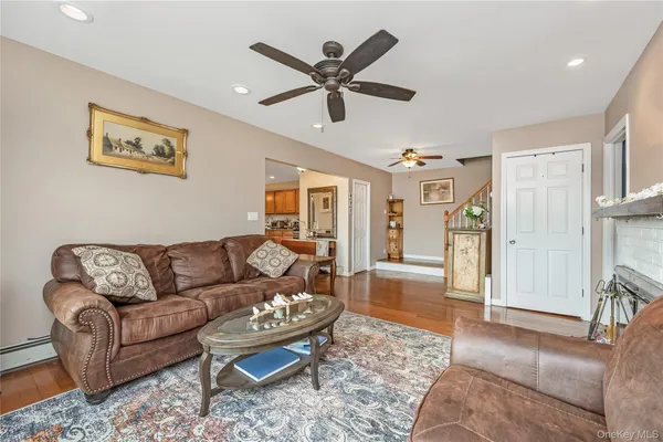 a living room with furniture and a ceiling fan