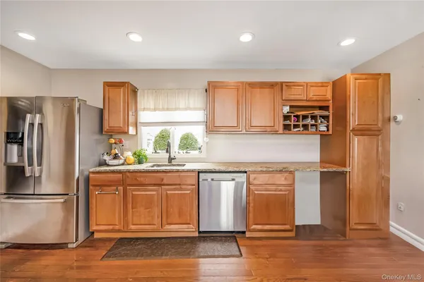 a kitchen with stainless steel appliances a refrigerator and wooden cabinets