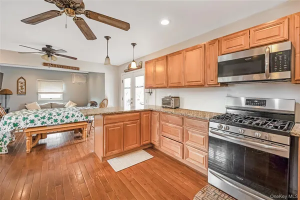 a kitchen with stainless steel appliances a stove a sink and a microwave