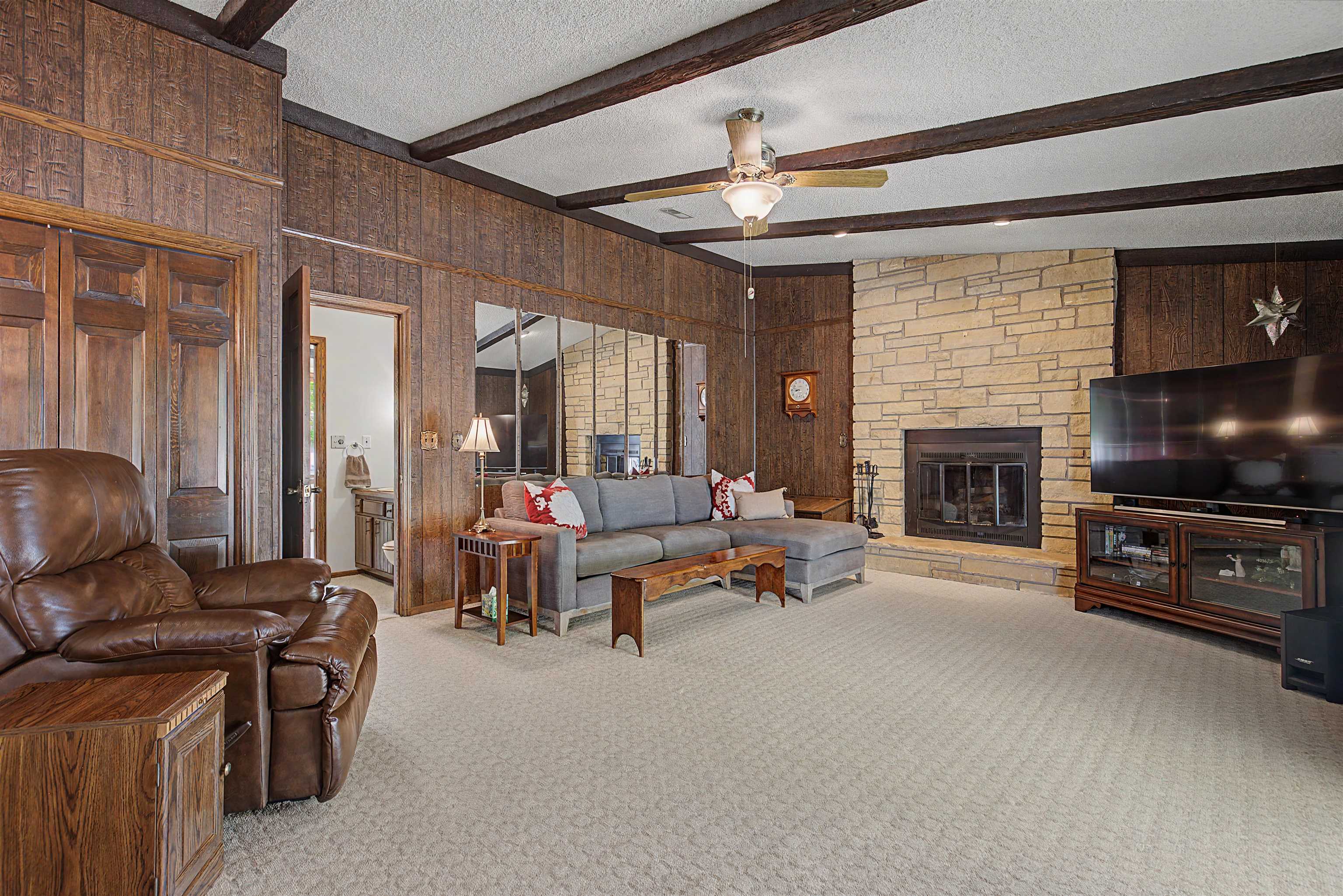 17380 Corbett Road Mount Carroll, IL 61053 - Photo 12 of 65 a living room with furniture a flat screen tv and a fireplace
