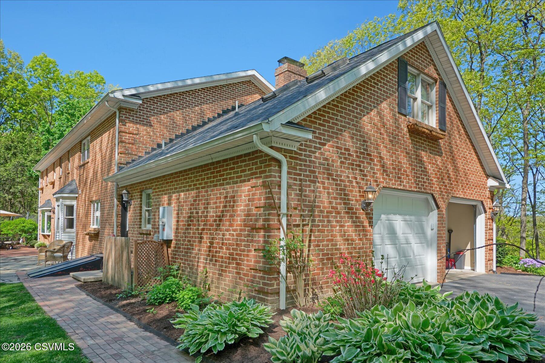 65 Crestview Drive Winfield, PA 17889 - Photo 53 of 70 a view of a house with brick walls and potted plants