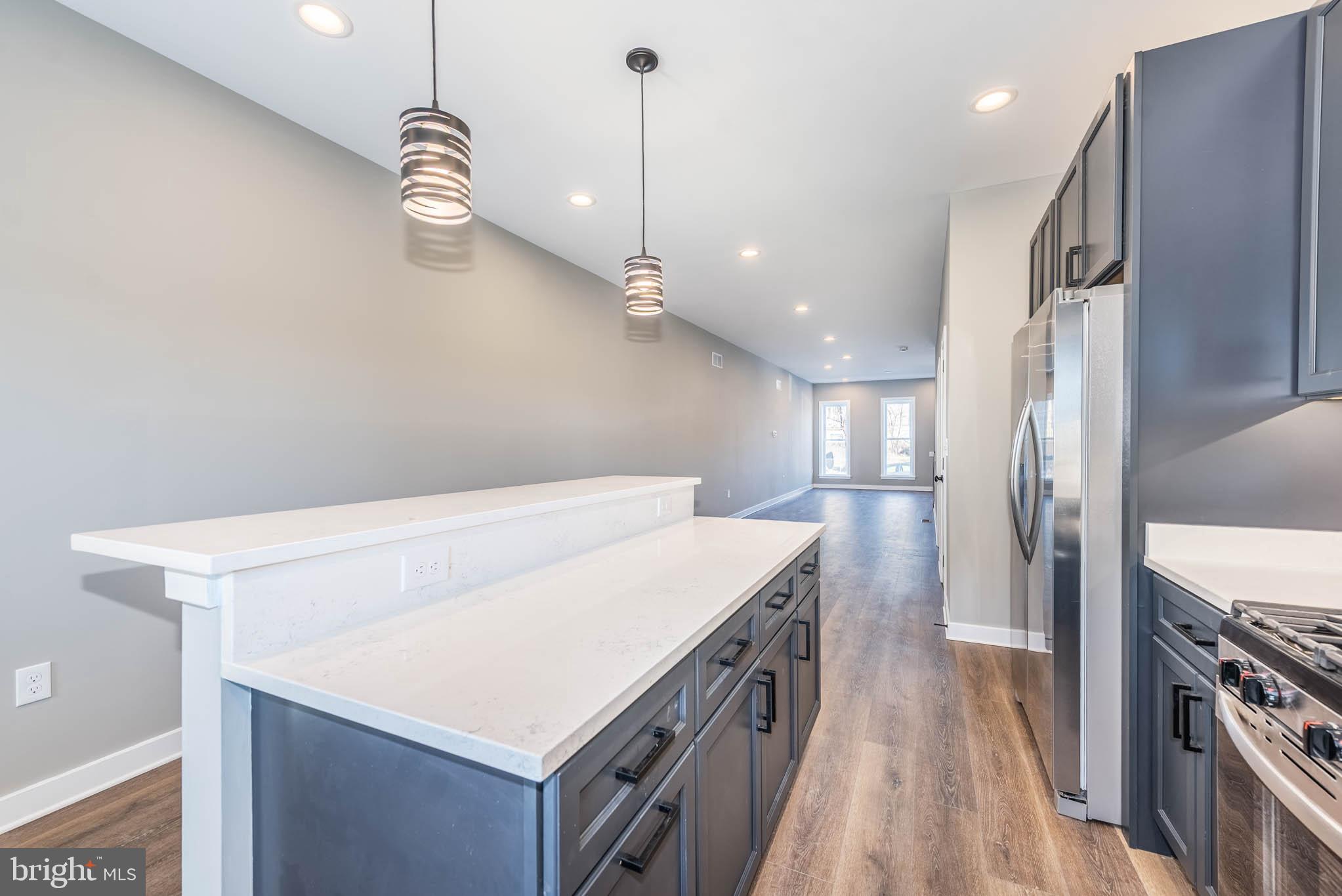 1330 Division Street Baltimore, MD 21217 - Photo 11 of 39 a kitchen that has a lot of cabinets and wooden floor