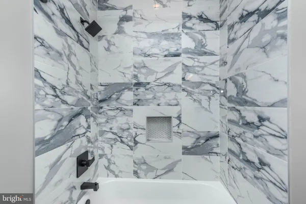 a bathroom with a bathtub and shower
