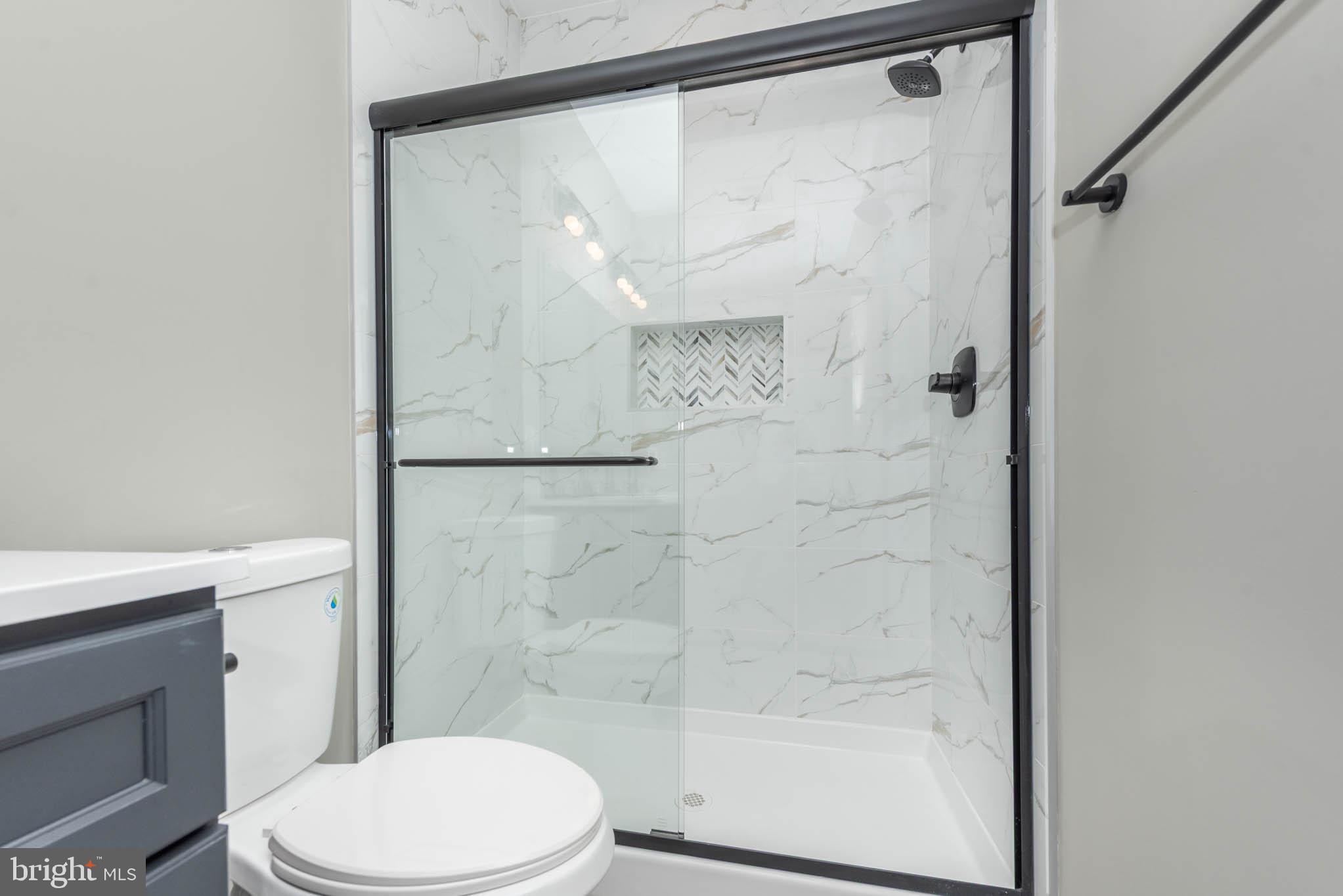 1330 Division Street Baltimore, MD 21217 - Photo 22 of 39 a white toilet sitting next to a shower