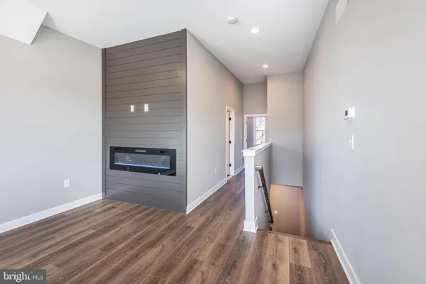 a view of a hardwood floor and an empty room
