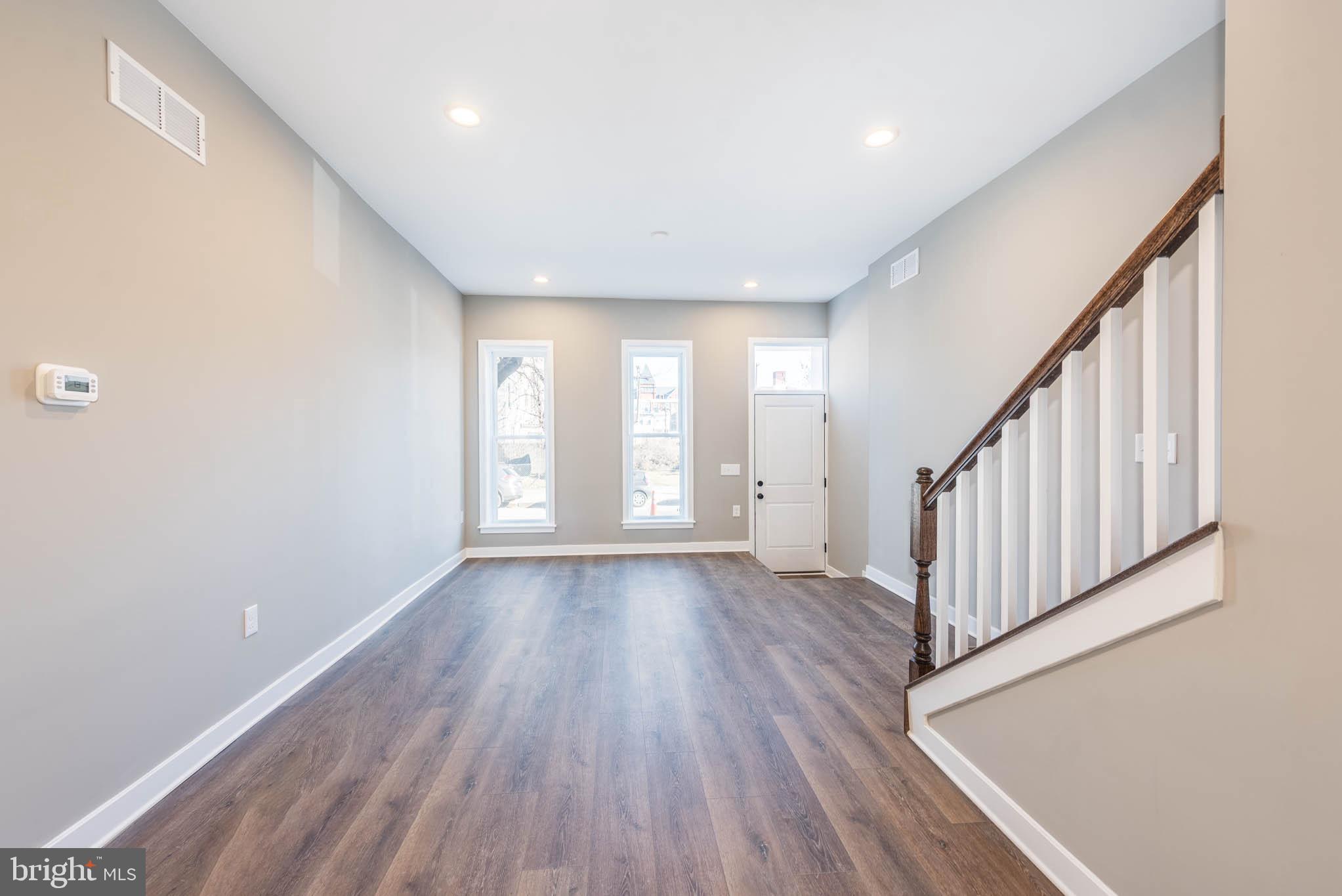 1330 Division Street Baltimore, MD 21217 - Photo 5 of 39 a view of a room with wooden floor and stairs