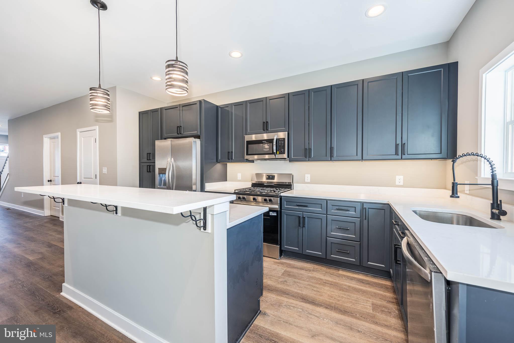 1330 Division Street Baltimore, MD 21217 - Photo 10 of 39 a kitchen with kitchen island granite countertop a sink stove and refrigerator