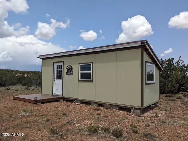 a view of a house with a backyard