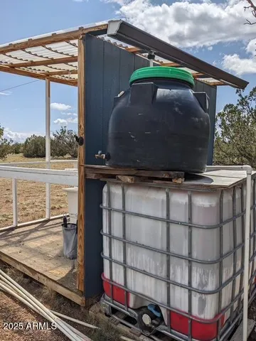 a view of house with wooden fence and a refrigerator