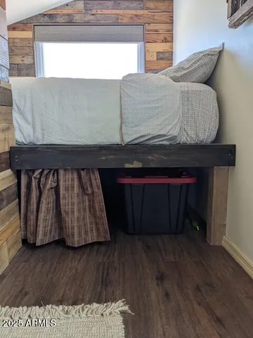 a living room with a couch and wooden floor