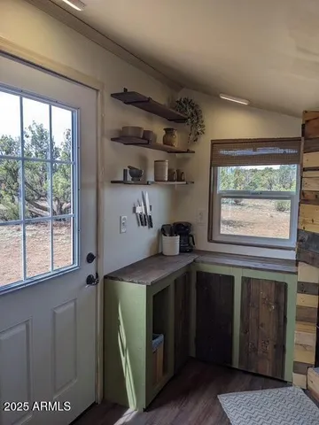 a kitchen with a stove a sink and a window