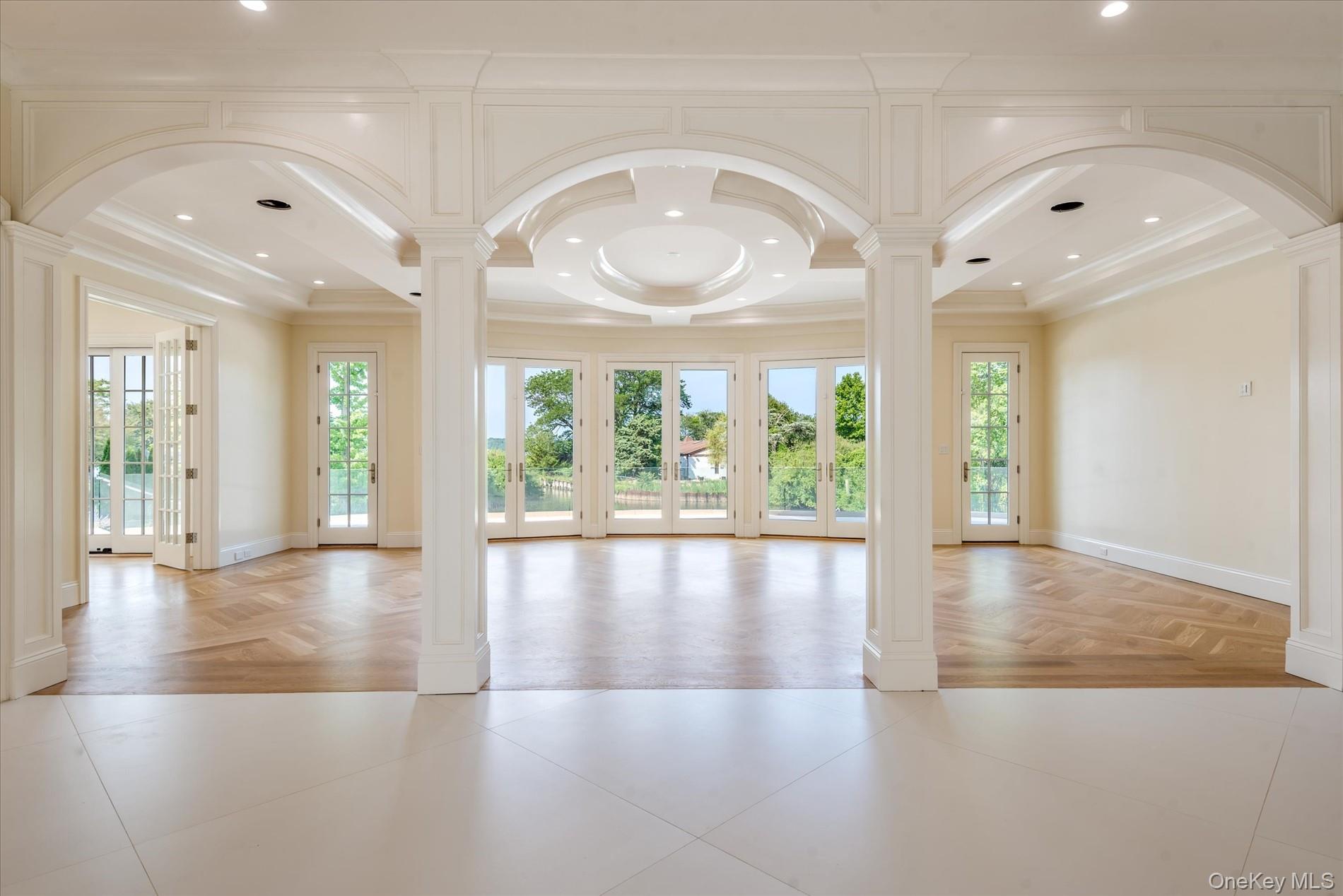 566 A East Shore Road Queens, NY 11024 - Photo 6 of 42 Spare room with decorative columns, arched walkways, recessed lighting, french doors, and ornamental molding