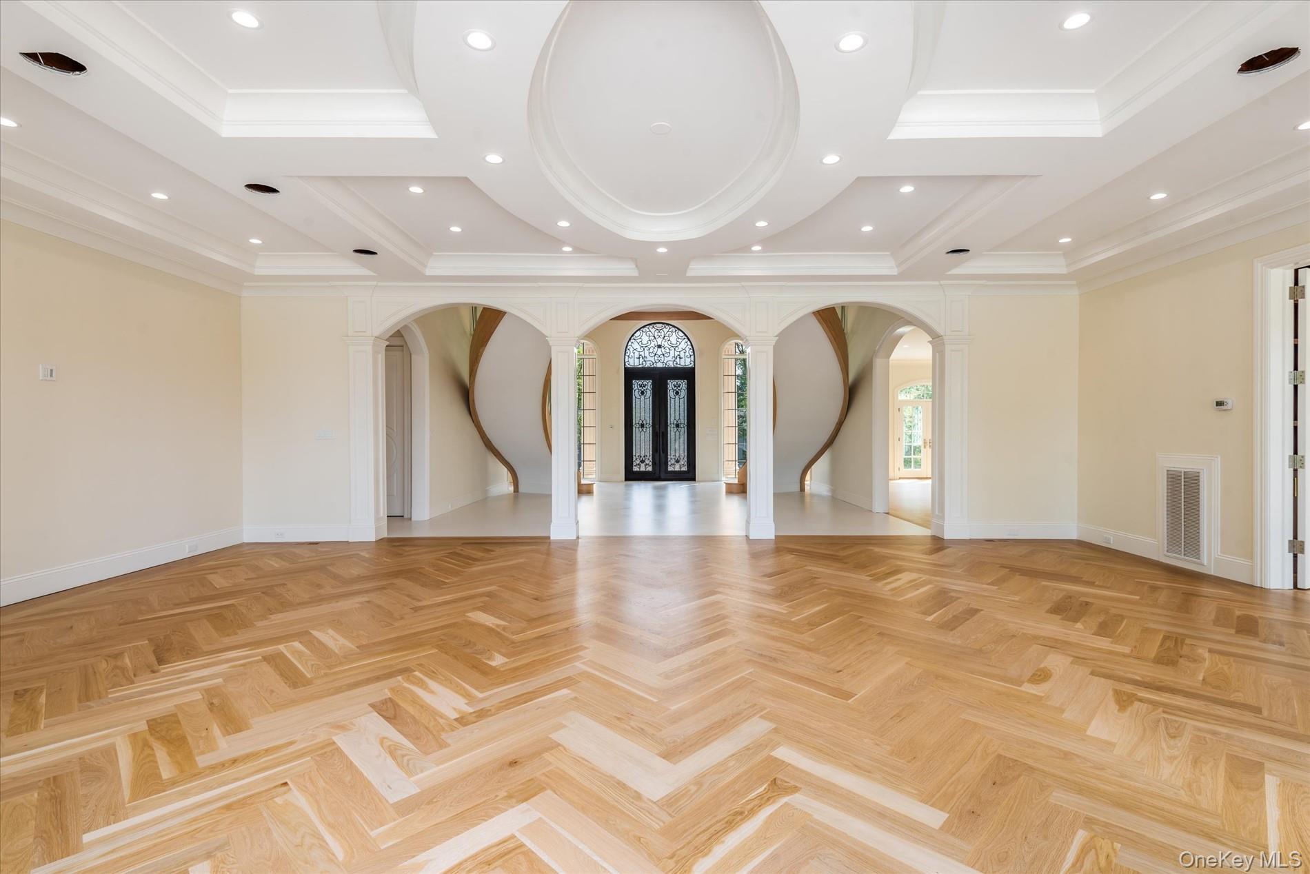 566 A East Shore Road Queens, NY 11024 - Photo 8 of 42 Empty room featuring ornate columns, french doors, arched walkways, recessed lighting, and ornamental molding
