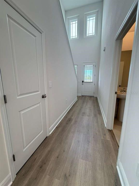 2265 Hen Road Minneola, FL 34715 - Photo 13 of 36 a view of a hallway with wooden floor and stairs