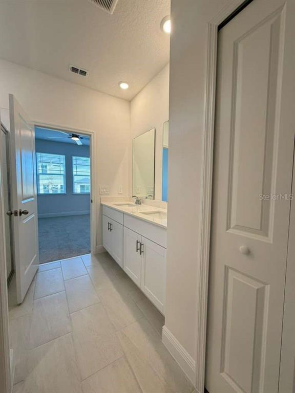 2265 Hen Road Minneola, FL 34715 - Photo 15 of 36 a bathroom with a sink a toilet and mirror