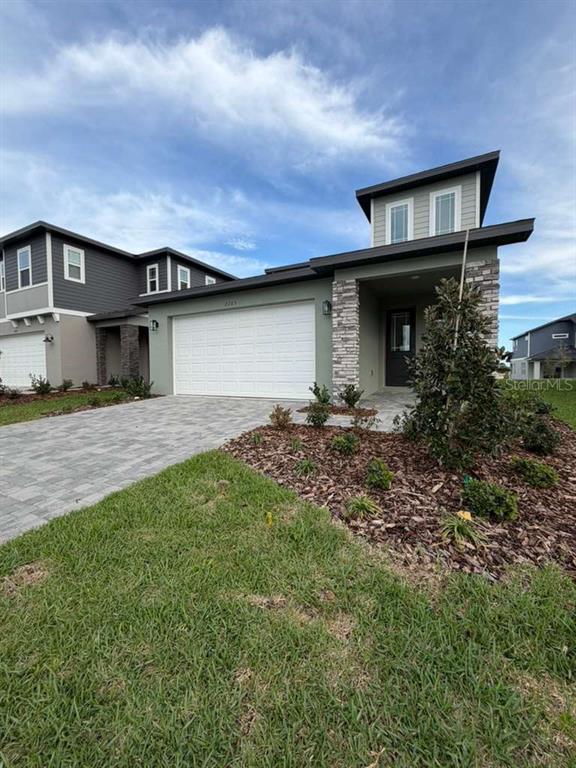 2265 Hen Road Minneola, FL 34715 - Photo 2 of 36 a front view of a house with garden