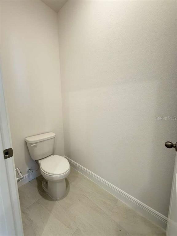 2265 Hen Road Minneola, FL 34715 - Photo 21 of 36 a white toilet sitting next to a white wall