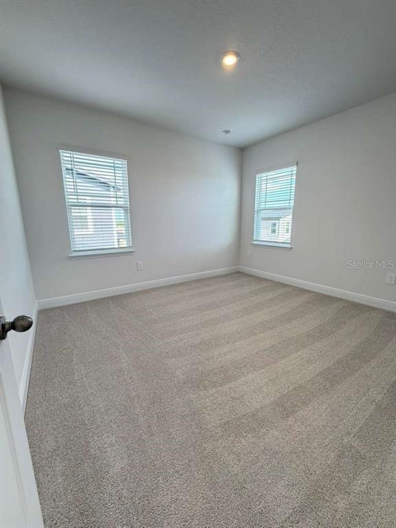 2265 Hen Road Minneola, FL 34715 - Photo 28 of 36 an empty room with windows