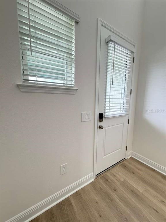 2265 Hen Road Minneola, FL 34715 - Photo 5 of 36 an empty room with wooden floor and a window