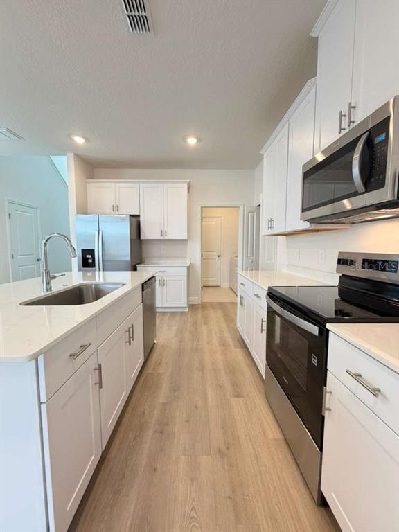 2265 Hen Road Minneola, FL 34715 - Photo 6 of 36 a large kitchen with stainless steel appliances