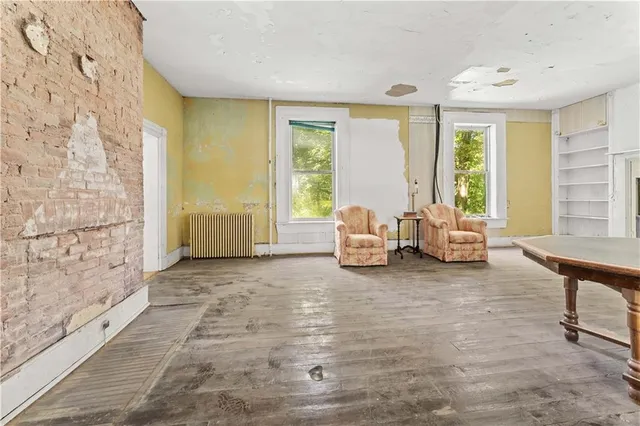 a living room with furniture and large windows