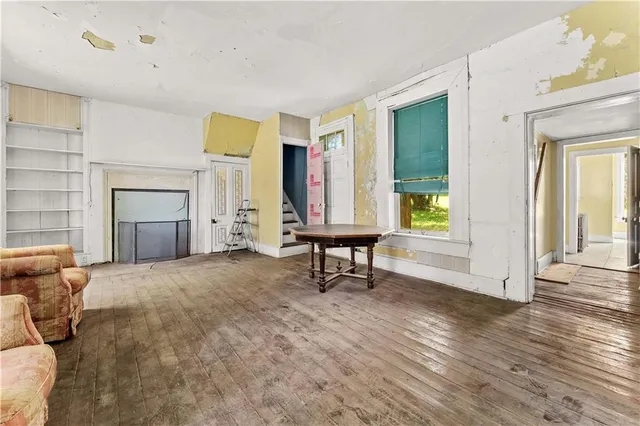 a furnished livingroom with windows and wooden floor