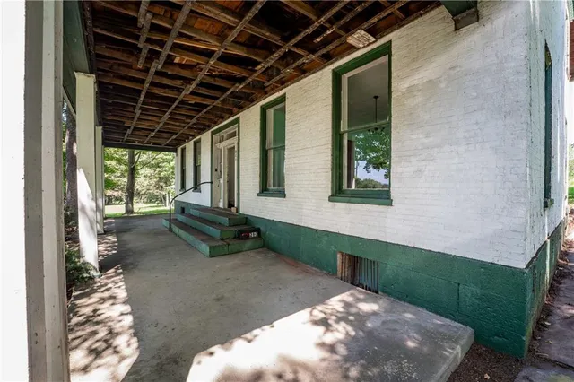 a backyard of a house with table and chairs