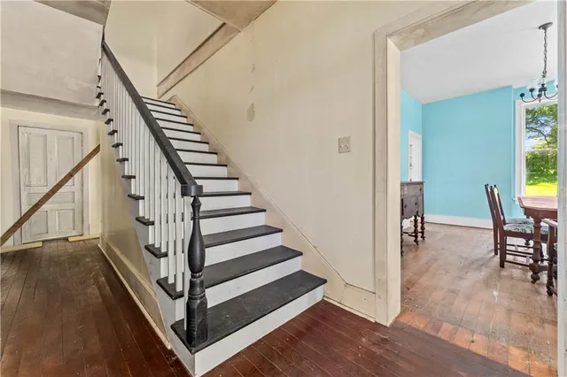 a view of a hallway with dining room and stairs