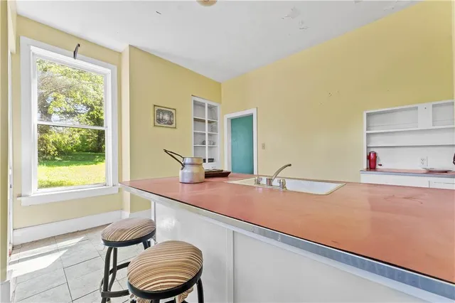 a hallway with a sink and a large window