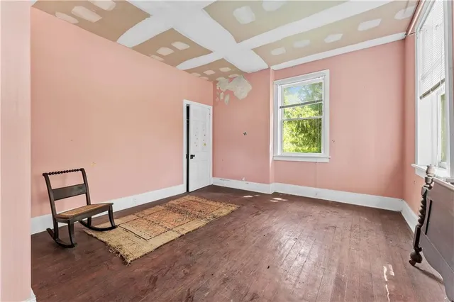 a view of a room with a window and wooden floor