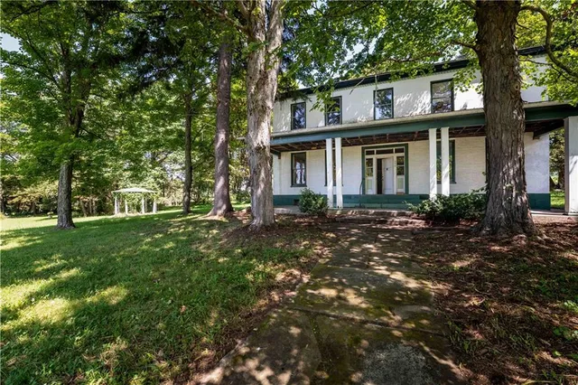 a front view of a house with a garden