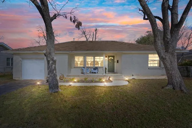 a view of a house with pool and sitting area