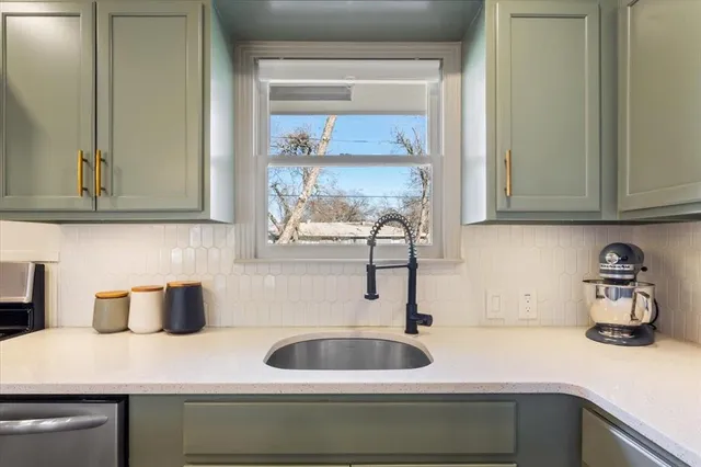 a kitchen with a sink and cabinets