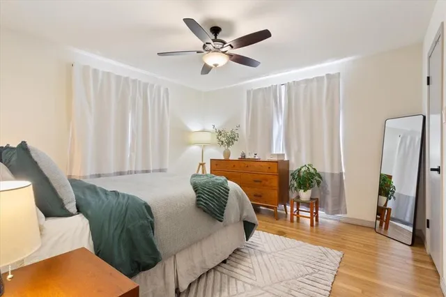 a living room with furniture and a large window with wooden floor