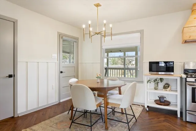 a view of a dining room with furniture window and wooden floor