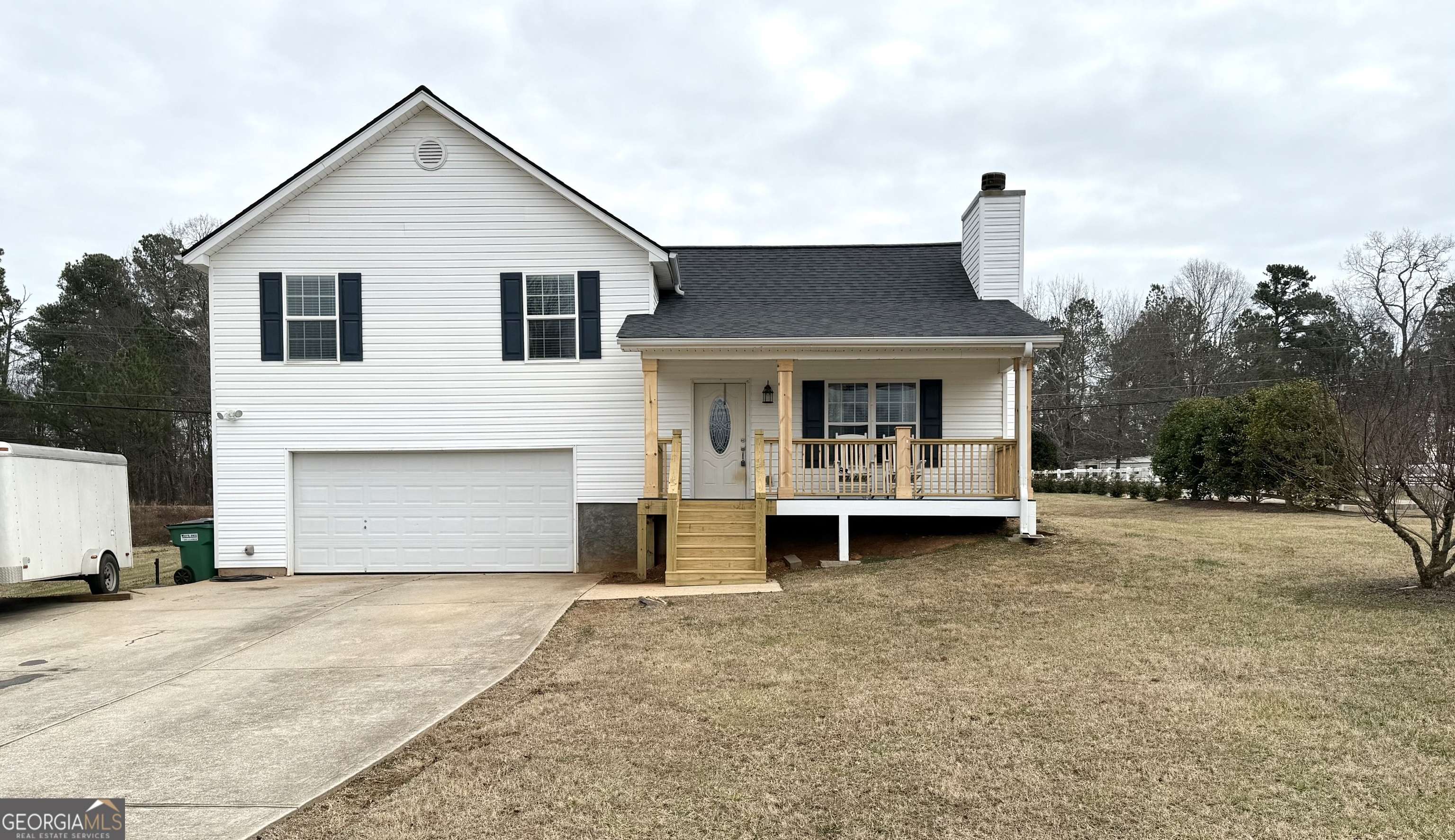 110 Waterloo Drive Mount Airy, GA 30563 - Photo 2 of 24 a front view of a house with a yard and garage