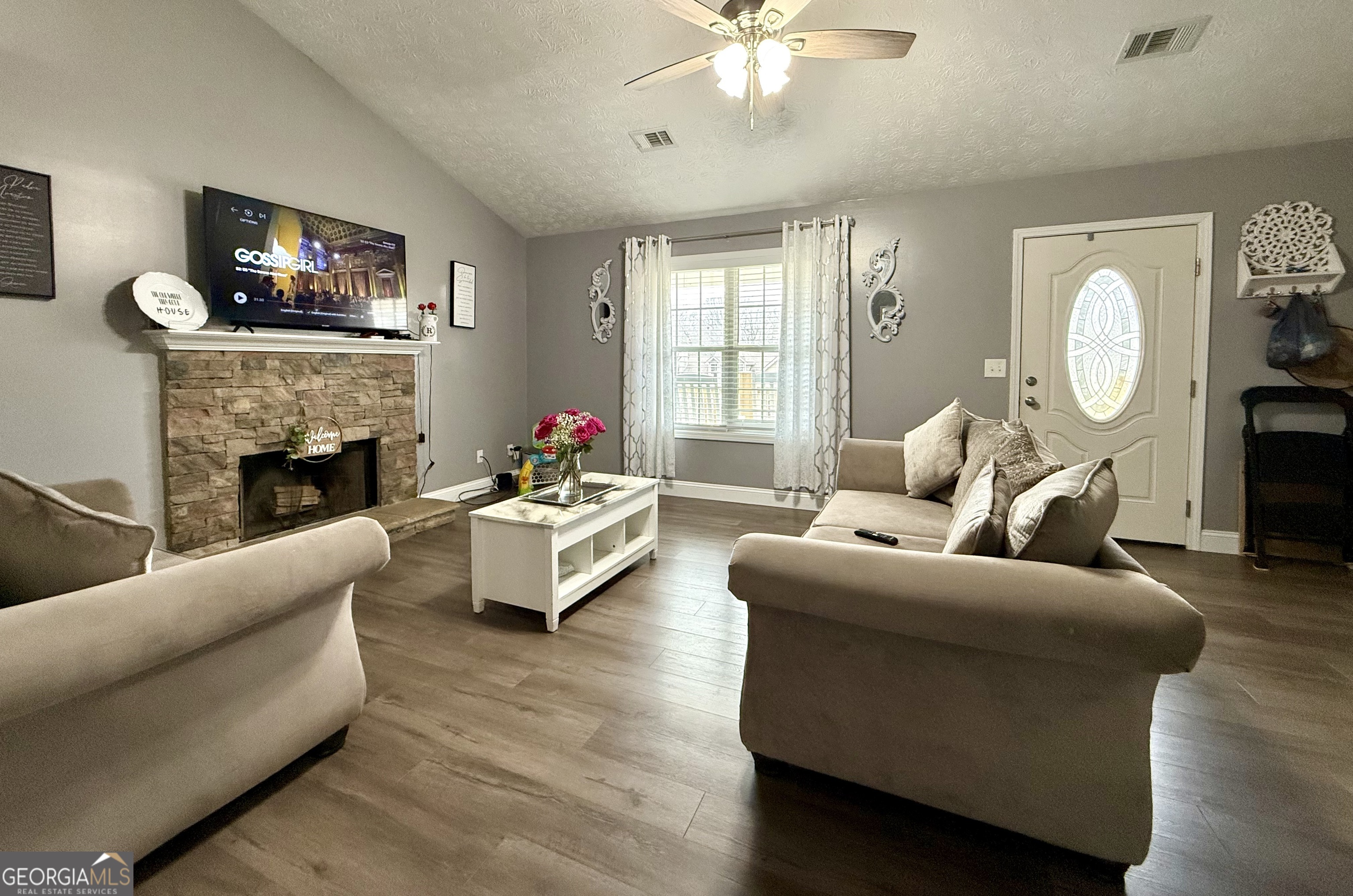 110 Waterloo Drive Mount Airy, GA 30563 - Photo 3 of 24 a living room with furniture a fireplace and a large window